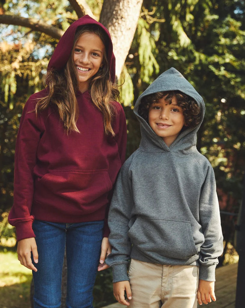 Two children wearing kids' Fairtrade organic hoodies in Burgundy and Sport Grey