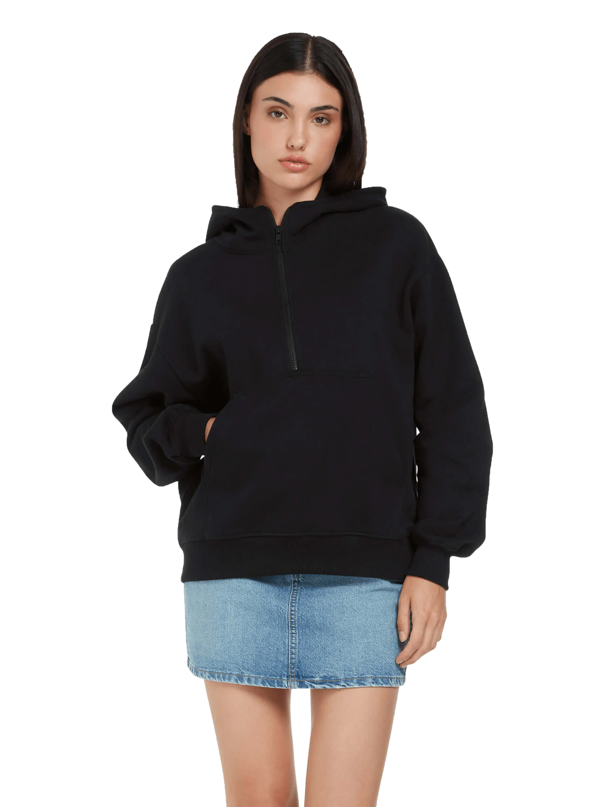 Model wearing the unisex organic half zip hoodie in black with a denim skirt, front view