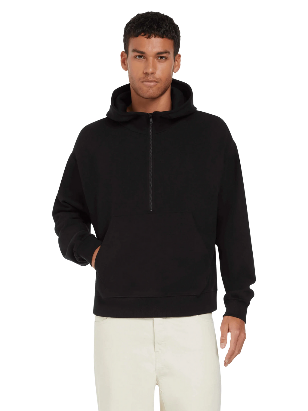 Model wearing the unisex organic half zip hoodie in black with light trousers, front view