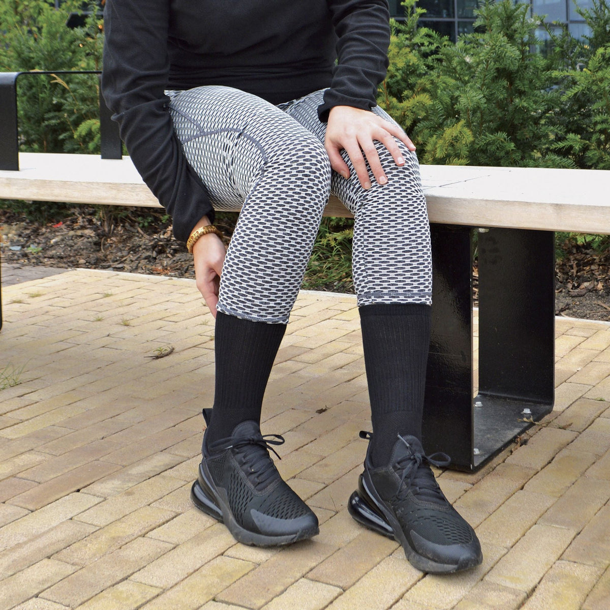 Men's bamboo running socks in Black, worn with leggings and trainers