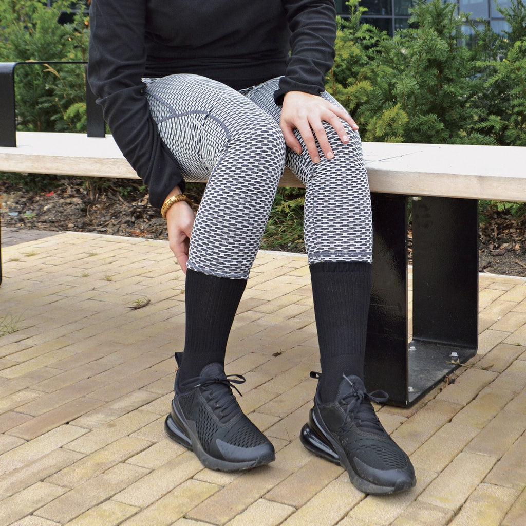 Men's bamboo running socks in Black, worn with leggings and trainers