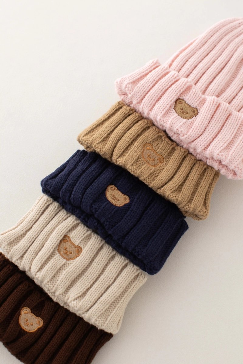 Kids' embroidered bear knitted beanie hats stacked to show the bear on each cuff, in assorted colours