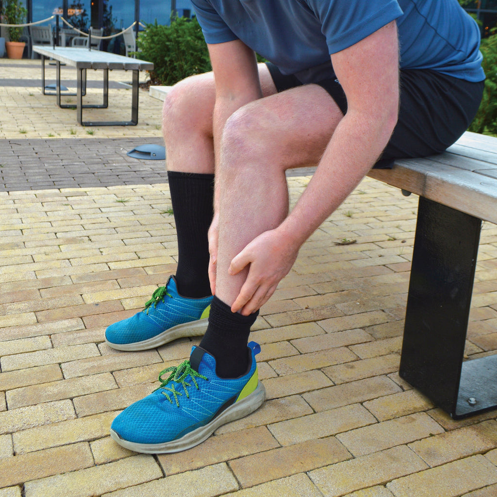 Men's bamboo running socks in Black, worn with running shoes