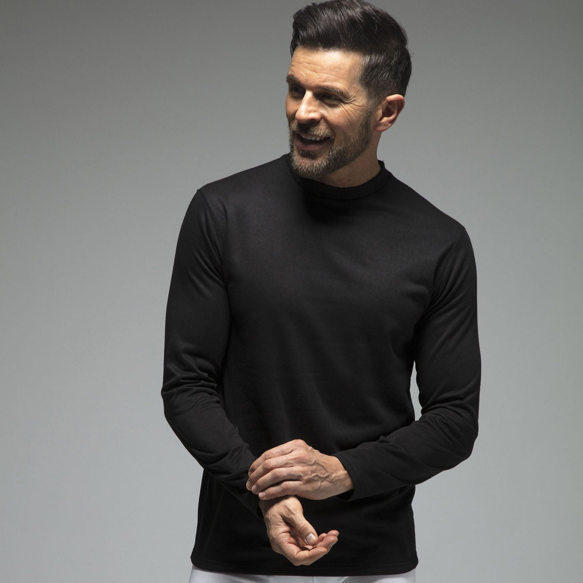 Men's fleece-lined thermal long sleeve top in Black, close-up worn by a model, three-quarter view