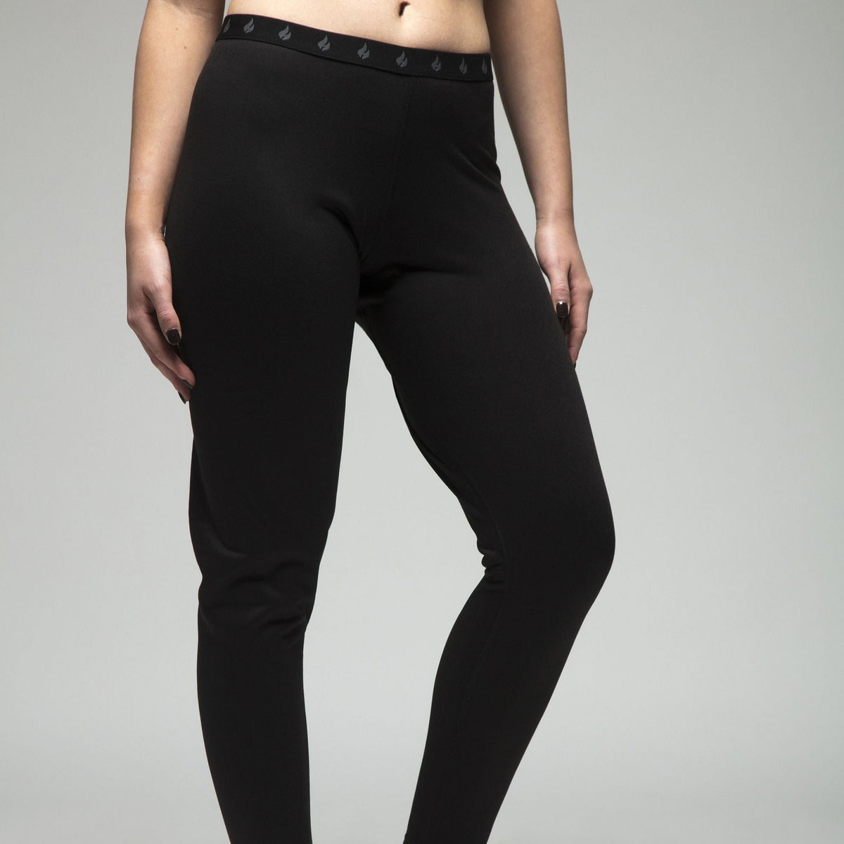 Women's fleece-lined thermal long johns in Black, close-up front view showing the waistband