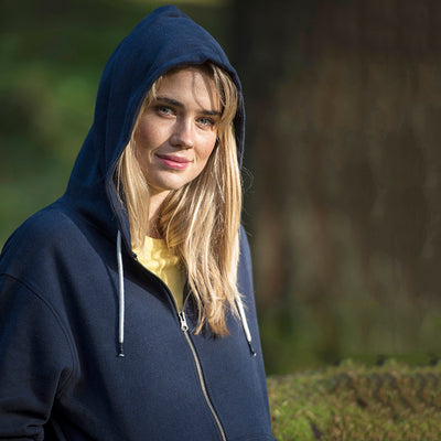 Woman wearing the recycled contrast zip hoodie in Navy/ Charcoal with the hood up