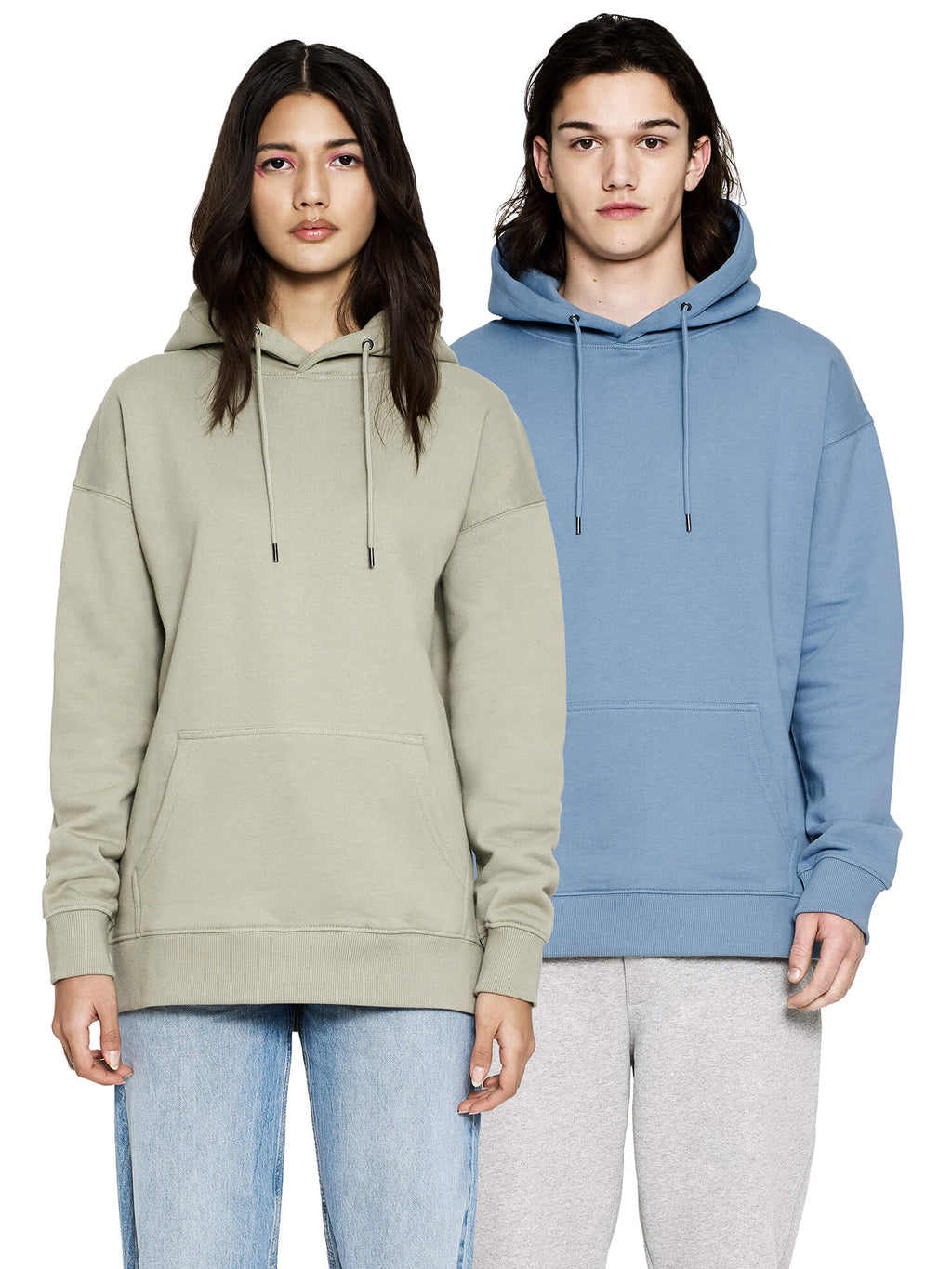 Woman in a pale green shade and man in Blue Dusk wearing the organic extra heavy dropped shoulder hoodie, front view
