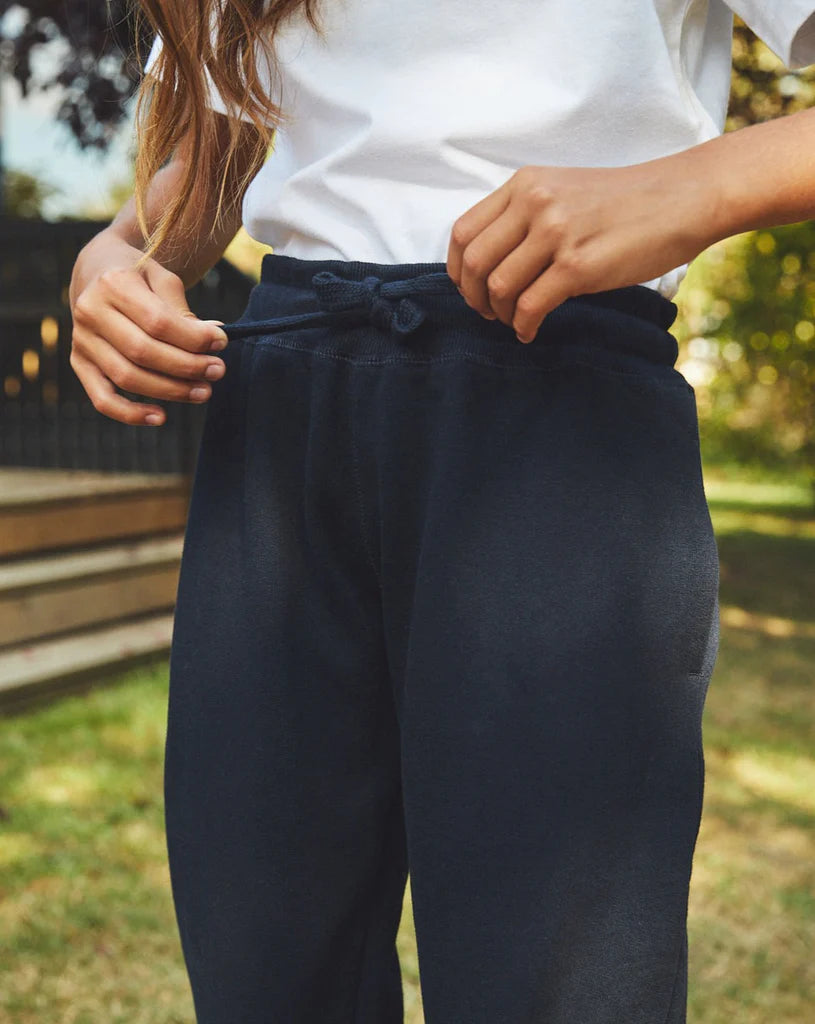 Close-up of the elastic waist and drawstrings on kids' Fairtrade organic sweatpants in Navy