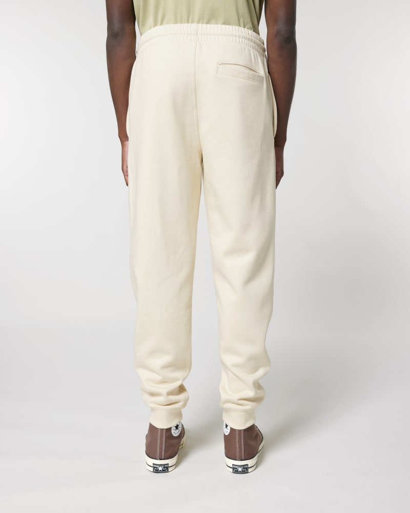 Model wearing unisex organic cotton sweatpants in Natural Raw, back view