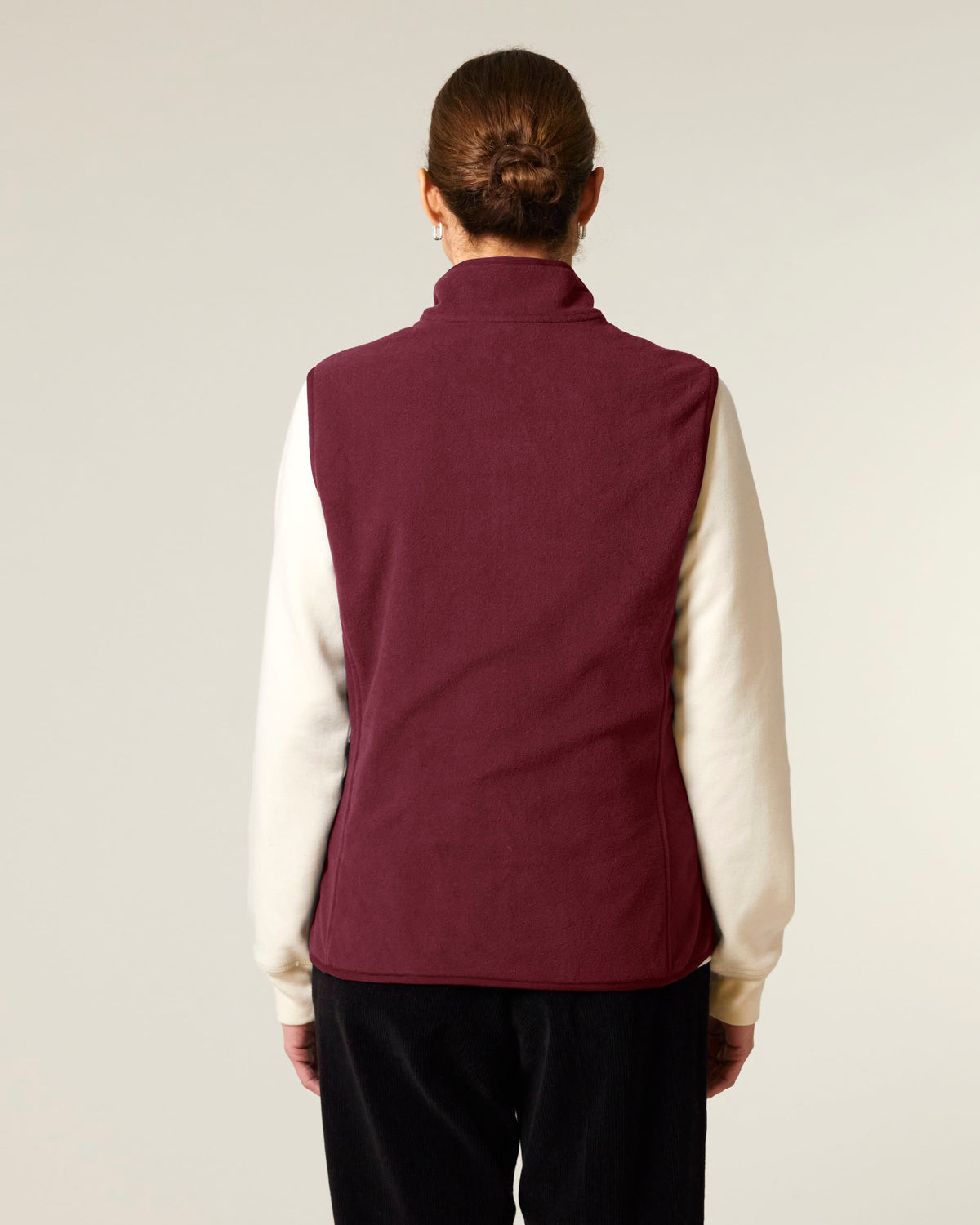 Model wearing the women's recycled fleece bodywarmer in Burgundy, back view