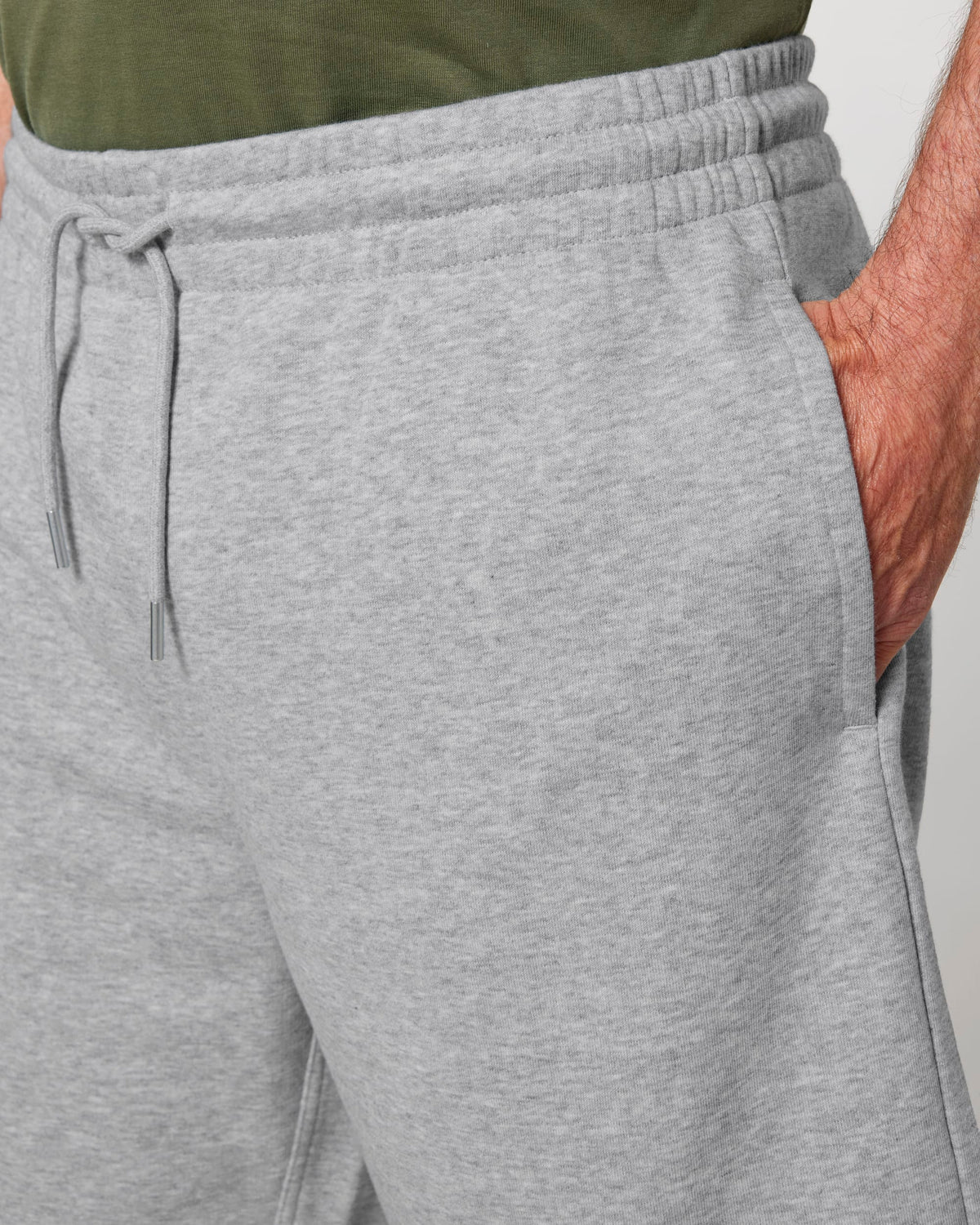 Close-up of the drawcord waistband and side pocket on the jogger shorts in Heather Grey