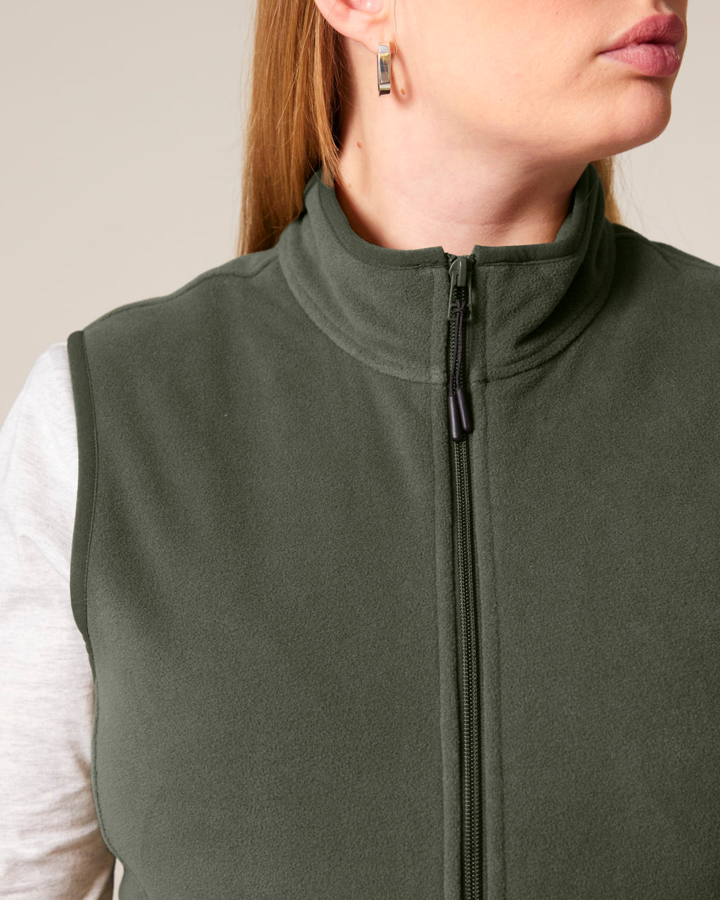 Close-up of the collar and zip on the women's recycled fleece bodywarmer in Khaki