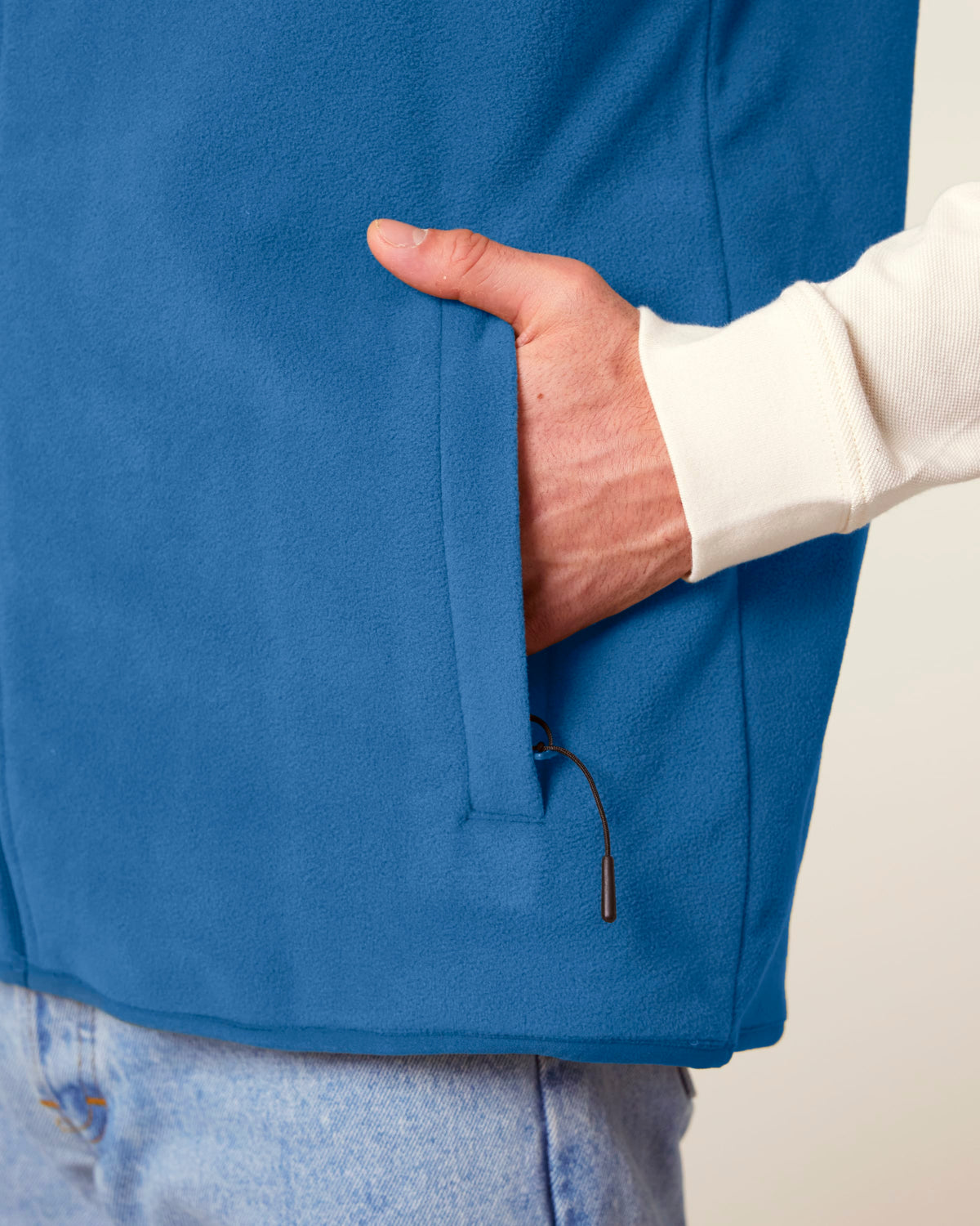 Close-up of the side pocket on the men's recycled fleece bodywarmer in Mindful Blue