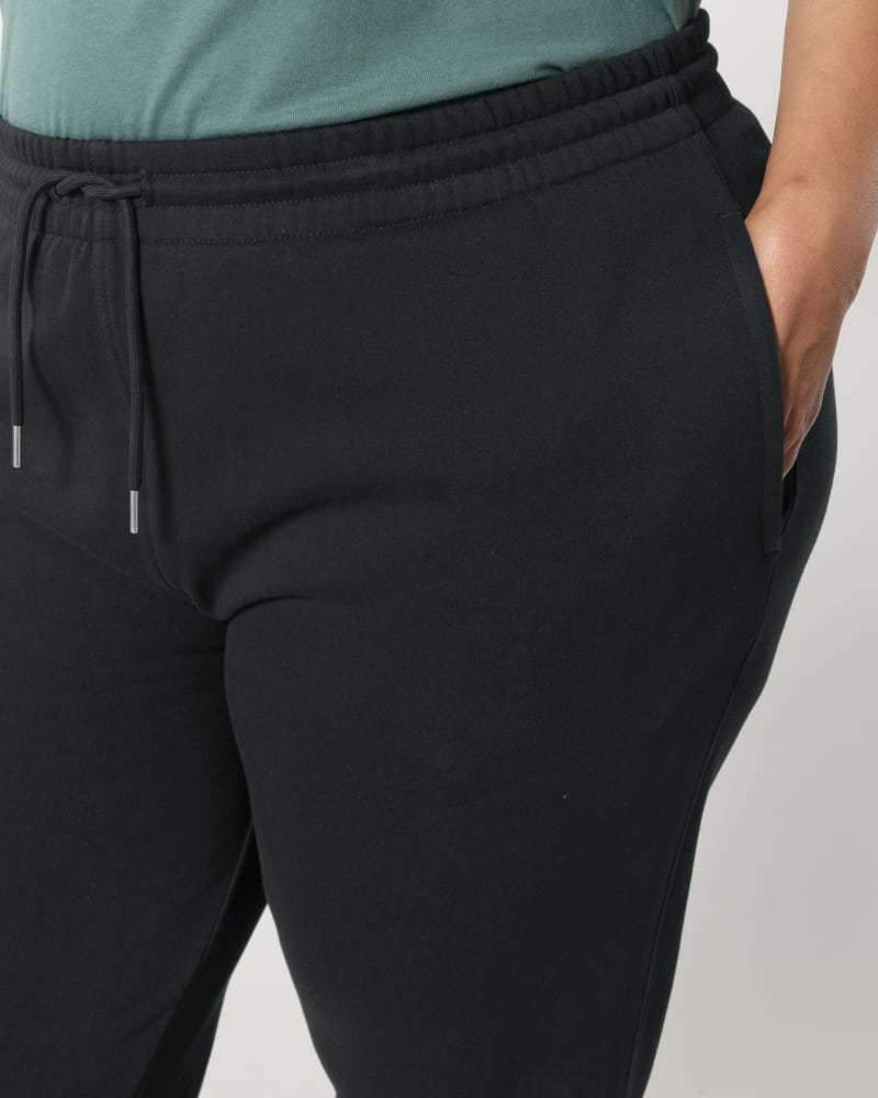 Close-up of the waistband, drawstring and side pocket on unisex organic cotton sweatpants in Black