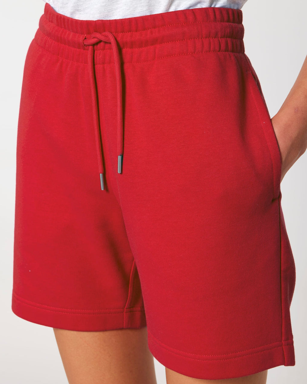 Close-up of the drawcord waistband and side pocket on the jogger shorts in Red