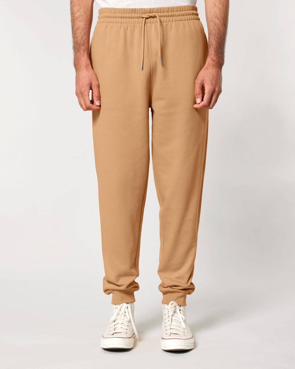 Model wearing unisex organic cotton sweatpants in Latte, front view
