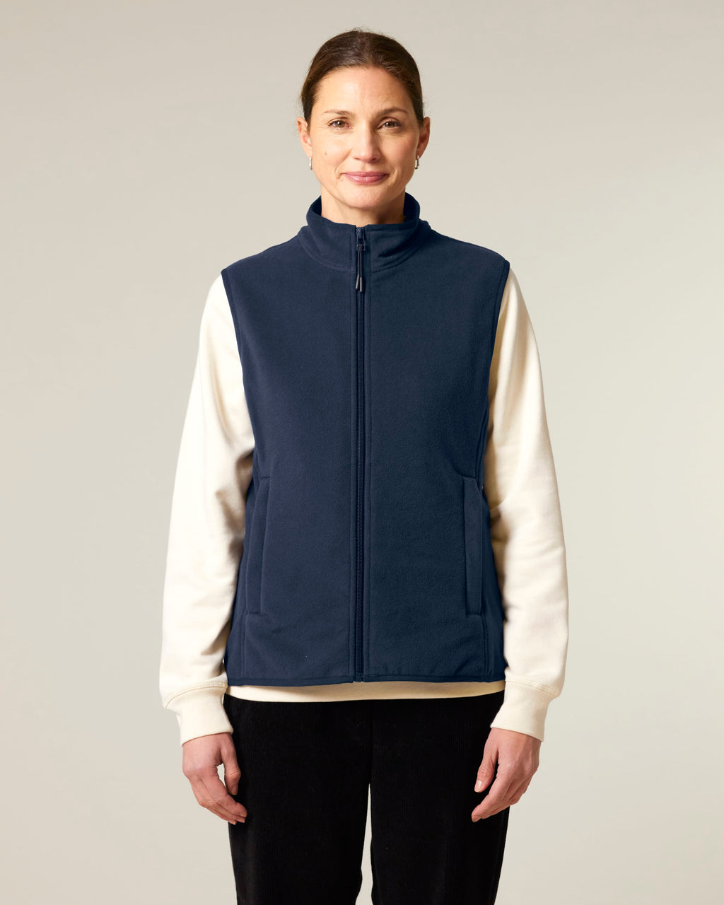 Model wearing the women's recycled fleece bodywarmer in French Navy, front view