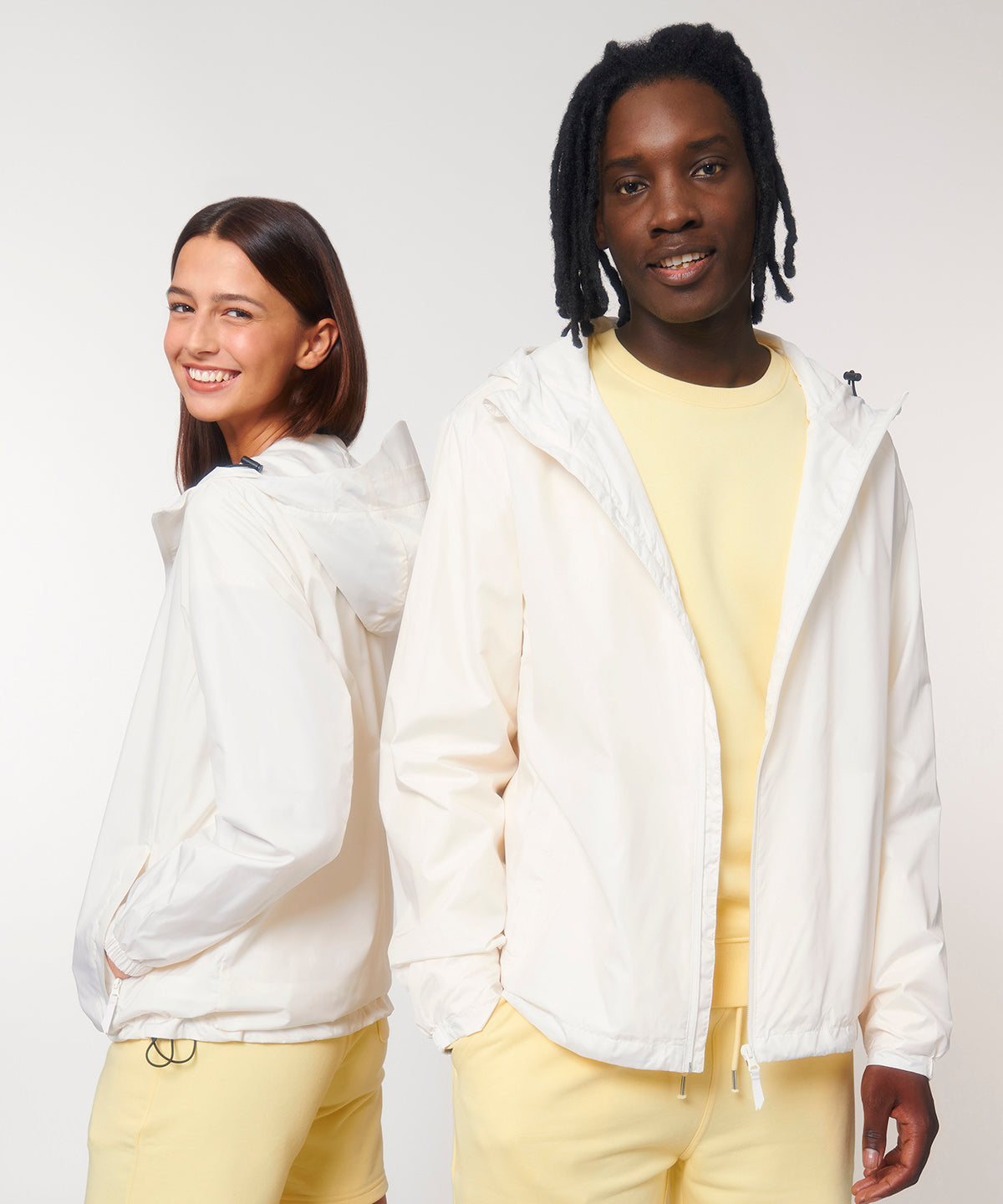 Man and woman wearing the recycled lightweight waterproof jacket in Off White